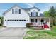 Charming two-story home with a two-car garage, covered porch, and landscaped front yard and a beautiful lawn at 2709 White Rail Dr, Fuquay Varina, NC 27526