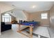Spacious game room with vaulted ceilings featuring a ping pong table and comfortable seating at 2709 White Rail Dr, Fuquay Varina, NC 27526