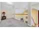Bright hallway featuring neutral carpet, natural light, and a wooden railing overlooking the living area at 2709 White Rail Dr, Fuquay Varina, NC 27526