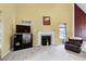 Spacious living room featuring a fireplace with black TV, and bright window light at 2709 White Rail Dr, Fuquay Varina, NC 27526
