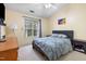 Bedroom with ceiling fan, carpet, large window and a full-sized bed with gray comforter at 2800 Trailwood Pines Ln # 301, Raleigh, NC 27603