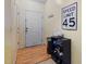 Hallway featuring wood-look floors and a white door with a speed limit sign on the wall at 2800 Trailwood Pines Ln # 301, Raleigh, NC 27603