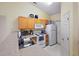 Kitchen with light wood cabinets, white appliances, and laminate countertops at 2800 Trailwood Pines Ln # 301, Raleigh, NC 27603