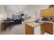 Open-concept living room and kitchen area featuring a ceiling fan and sliding glass door to a balcony at 2800 Trailwood Pines Ln # 301, Raleigh, NC 27603