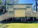 View of the backyard showing the two-story home with dual wooden decks on a sunny day at 2809 Haven Rd, Raleigh, NC 27610