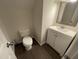 This is a half bathroom with laminate flooring, a white toilet, and a vanity at 2809 Haven Rd, Raleigh, NC 27610