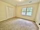 This is a bedroom with carpet, a closet, and one window allowing for lots of natural light at 2809 Haven Rd, Raleigh, NC 27610