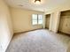 Bright bedroom with a window, carpet floors, and closet offers a comfortable and inviting space at 2809 Haven Rd, Raleigh, NC 27610