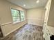 Charming dining area featuring gray wood-look flooring, natural light, and trim at 2809 Haven Rd, Raleigh, NC 27610