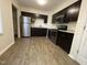 Modern kitchen features stainless steel appliances, stylish dark cabinets, and luxury vinyl plank flooring at 2809 Haven Rd, Raleigh, NC 27610