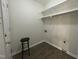 This is a laundry room with laminate flooring, shelving, and washer and dryer hookups at 2809 Haven Rd, Raleigh, NC 27610