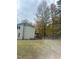 A view of the home’s backyard featuring trees and white fencing at 306 Smoketree Way, Louisburg, NC 27549