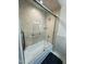 Clean bathroom featuring a glass shower door and updated shower fixtures and neutral tiling at 306 Smoketree Way, Louisburg, NC 27549