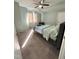 Light-filled bedroom featuring a queen size bed and carpet flooring at 306 Smoketree Way, Louisburg, NC 27549
