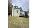 A view of the home’s backyard and side featuring white fencing and covered porch area at 306 Smoketree Way, Louisburg, NC 27549