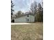 A view of the side of the home featuring backyard and driveway at 306 Smoketree Way, Louisburg, NC 27549