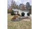 Charming home featuring stone accents, a well-manicured lawn, and a convenient attached two-car garage at 306 Smoketree Way, Louisburg, NC 27549