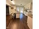 Well-lit kitchen with granite countertops, modern appliances, and dark wood flooring at 306 Smoketree Way, Louisburg, NC 27549