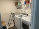 Functional laundry room with modern washer and dryer, shelving, and ample space for laundry tasks at 307 King Closer Dr, Cary, NC 27519