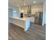 Modern kitchen featuring a large island, stainless steel appliances, and sleek white cabinets at 3102 Kempthorne Rd # 49, Cary, NC 27519