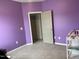 Cozy purple Bedroom with a crib, changing table, swing, and a serene atmosphere at 316 Nickleby Way, Wendell, NC 27591