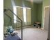 A cozy bedroom space featuring green walls, light carpet, and a window with curtains at 316 Nickleby Way, Wendell, NC 27591