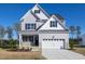 Charming two-story home featuring a gray exterior, white trim, and a well-manicured lawn on a sunny day at 316 Nickleby Way, Wendell, NC 27591