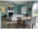 Open concept living area featuring modern sofa, dining table, and a view to the backyard at 316 Nickleby Way, Wendell, NC 27591