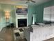 Inviting living room featuring a gray sofa, fireplace with TV, and modern decor at 316 Nickleby Way, Wendell, NC 27591