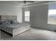 Serene primary bedroom featuring neutral tones, a plush bed, and ample natural light from large windows at 316 Nickleby Way, Wendell, NC 27591