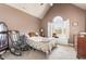 Cozy bedroom under a vaulted ceiling featuring a decorative window and classic furnishings at 316 Pebble Beach Dr, Mebane, NC 27302