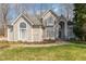 Elegant home with arched windows and a well-kept lawn, creating a welcoming curb appeal at 316 Pebble Beach Dr, Mebane, NC 27302