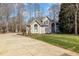 Charming home features a well-manicured lawn, complemented by a long driveway, and mature trees at 316 Pebble Beach Dr, Mebane, NC 27302