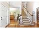 Inviting foyer featuring hardwood floors, a staircase, and entryways to adjacent rooms at 316 Pebble Beach Dr, Mebane, NC 27302