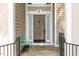 Close-up showcasing the elegant front door entrance with charming bench seating at 316 Pebble Beach Dr, Mebane, NC 27302