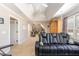 Large living room featuring a drop ceiling with ceiling fans, and a large black leather sofa at 316 Pebble Beach Dr, Mebane, NC 27302
