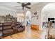 A spacious living room featuring hardwood floors, a ceiling fan, and access to other areas of the house at 316 Pebble Beach Dr, Mebane, NC 27302