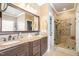 Spacious bathroom featuring double sinks, granite countertops, and a glass enclosed shower at 316 Pebble Beach Dr, Mebane, NC 27302