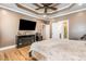 Comfortable main bedroom with a large television, and a doorway that leads to the bathroom at 316 Pebble Beach Dr, Mebane, NC 27302