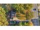 Aerial view of a property showcasing its well-maintained lawn, landscaping, and proximity to the road at 347 Cook Rd, Elon, NC 27244
