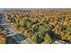Aerial view of a beautiful neighborhood surrounded by trees in various shades of green, yellow, orange, and red at 347 Cook Rd, Elon, NC 27244
