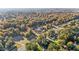 Aerial view of a beautiful neighborhood surrounded by trees in various shades of green, yellow, orange, and red at 347 Cook Rd, Elon, NC 27244