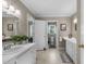 Bright bathroom with dual vanities, white cabinets, and a separate toilet area for added privacy at 347 Cook Rd, Elon, NC 27244