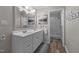 Bright bathroom featuring a double vanity, a large mirror, and a walk-in shower with decorative wall tiles at 347 Cook Rd, Elon, NC 27244