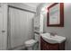 Small bathroom with a wood vanity, toilet, mirror, and shower with shower curtain at 347 Cook Rd, Elon, NC 27244