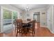 A cozy dining area featuring a large table, chairs, and sliding doors that lead to the outdoor deck at 347 Cook Rd, Elon, NC 27244