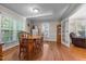 Bright dining room with hardwood floors, a wooden table with seating, and natural light at 347 Cook Rd, Elon, NC 27244