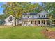 Charming two-story home featuring a covered front porch and attached garage in a lush, green yard at 347 Cook Rd, Elon, NC 27244