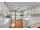 Functional kitchen featuring white cabinets, wood-look floors, and ample countertop space at 347 Cook Rd, Elon, NC 27244