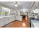 Functional kitchen featuring white cabinets, wood-look floors, and ample countertop space at 347 Cook Rd, Elon, NC 27244